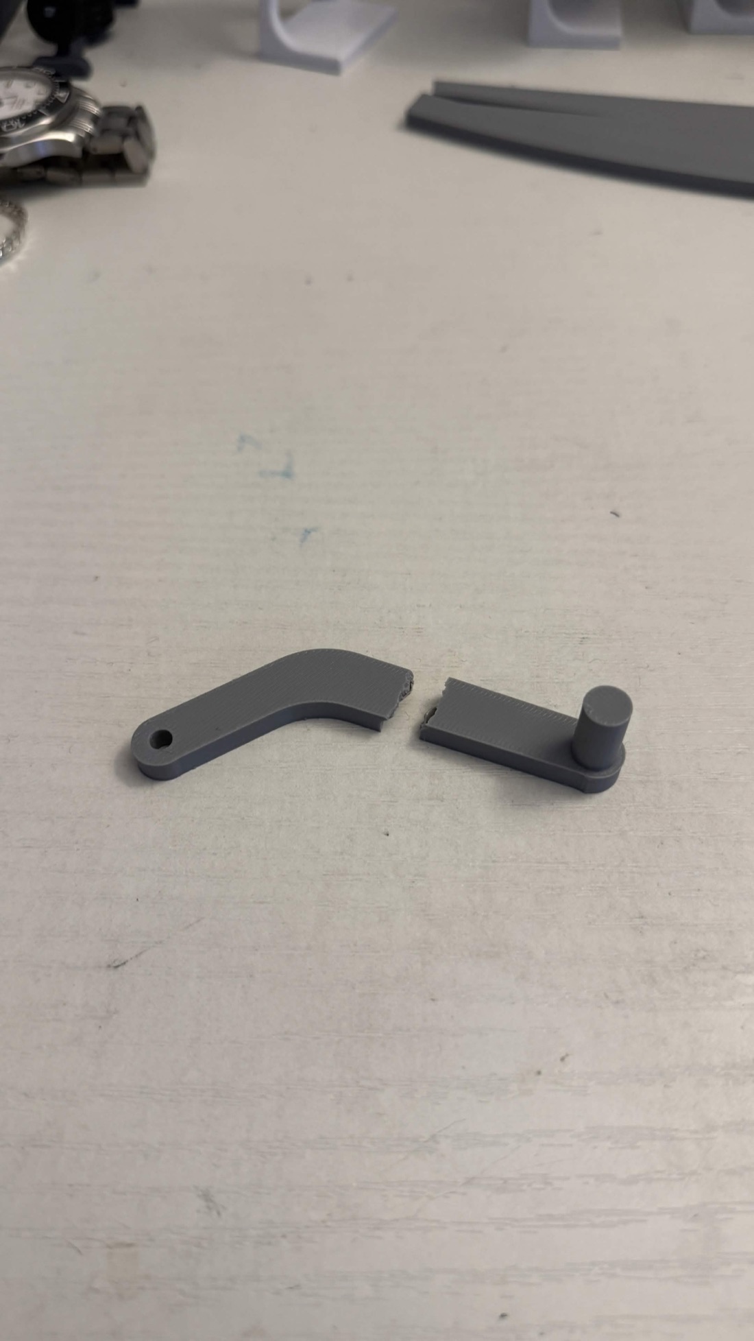 The fractured connecting arm, showing the failure at a thin structural section