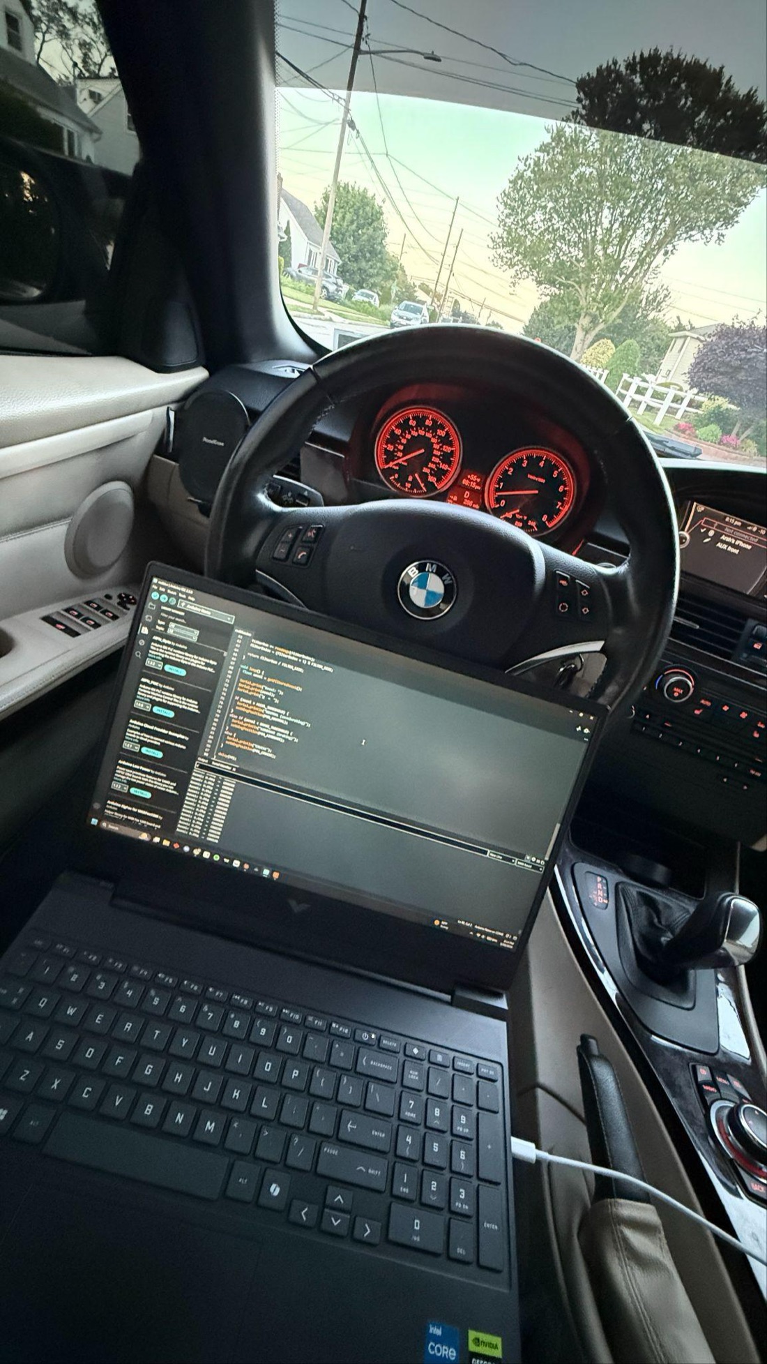 A laptop in the passenger seat showing live g-force readings from the IMU